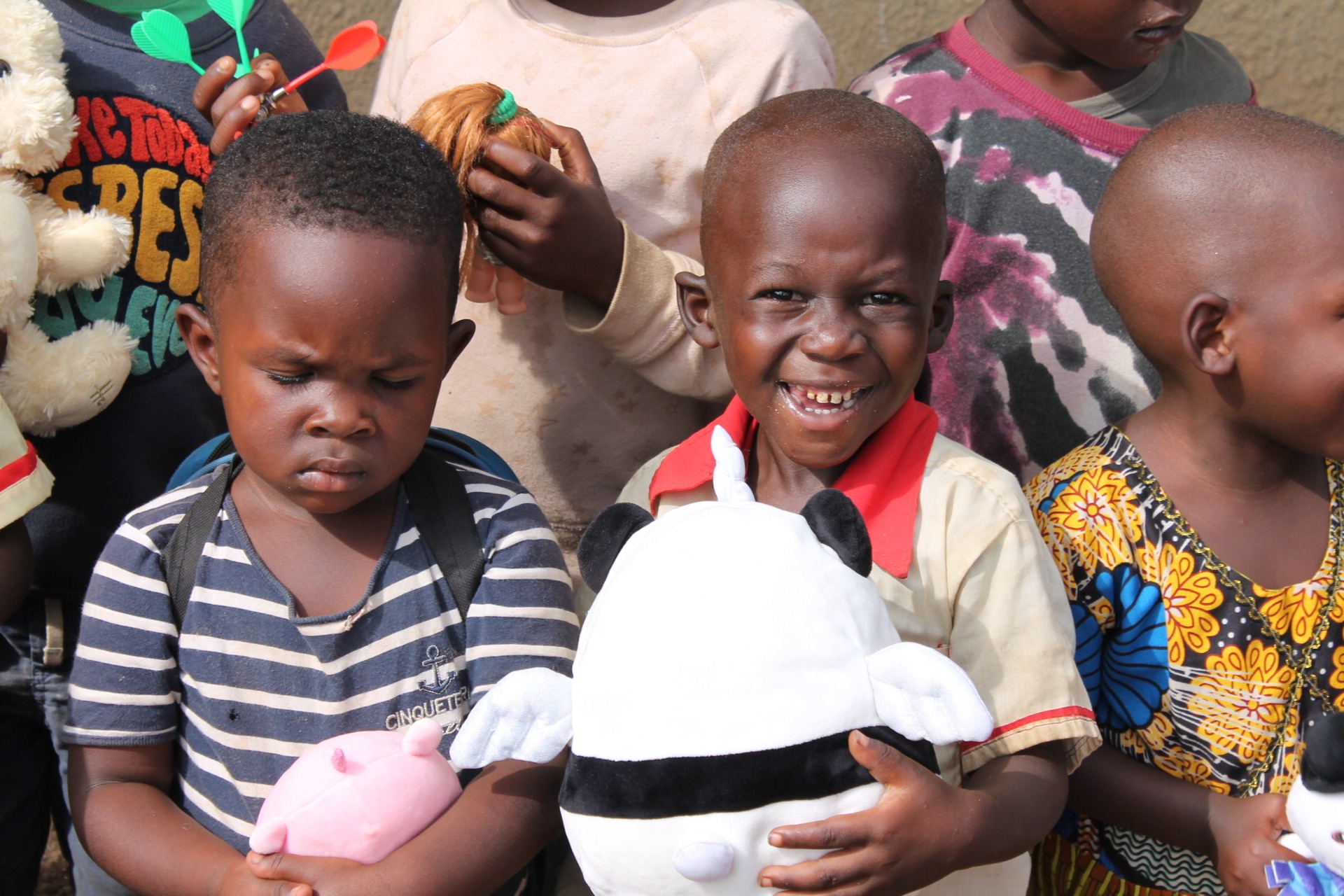 Children holding soft toys